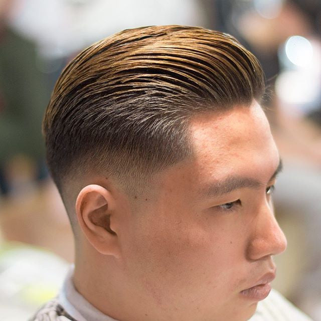 Slicked-back hairstyle styled with Suavecito pomade